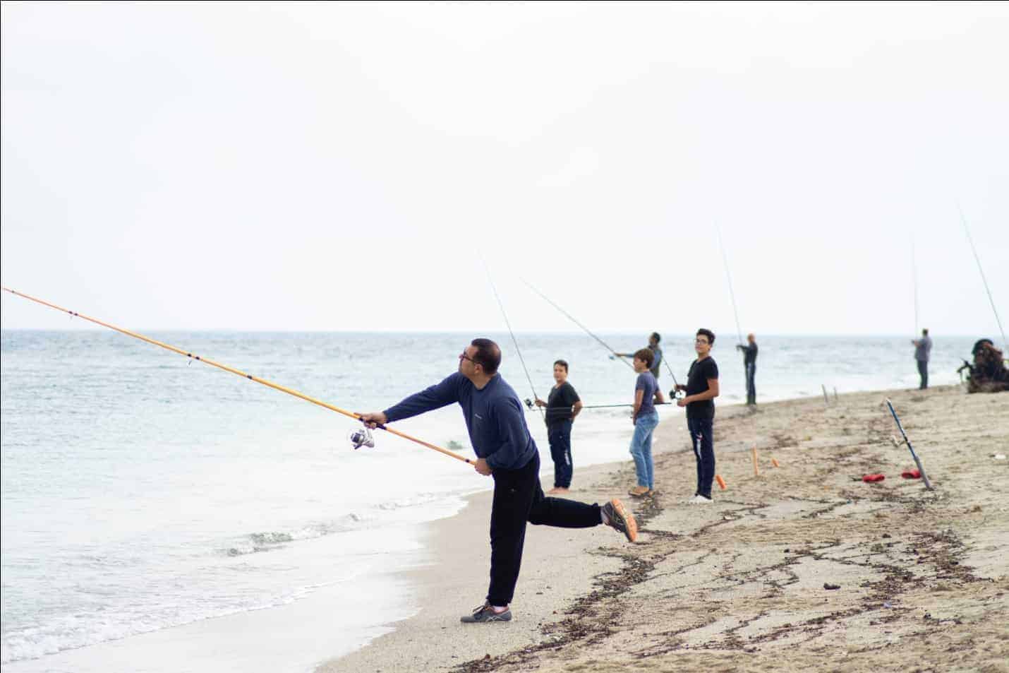 People Fishing On the Seashore